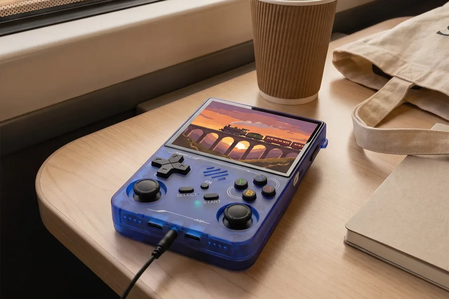 Blue R36XX on a train tray table, wired earphones plugged in